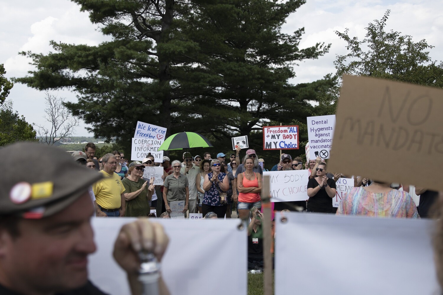 Health care workers, supporters protest vaccine mandate in