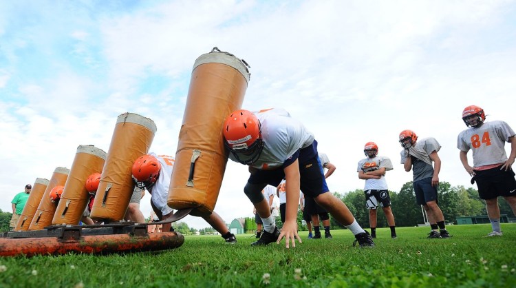 15254# 01block WINSLOW, MAINE AUGUST 18, 2021. Winslow High School linebackers work trough a blocking drill during football practice at Winslow High School in Winslow, Maine Wednesday August 18, 2021. (Rich Abrahamson/Morning Sentinel)