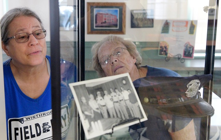 WINTHROP, ME - AUGUST 17: Winthrop Maine Historical Society President Lynda Pratt right and member Mary Richards examine items on display at the groupÕs new building on Main Street in Winthrop on Tuesday August 17, 2021. Andy Molloy/Kennebec Journal