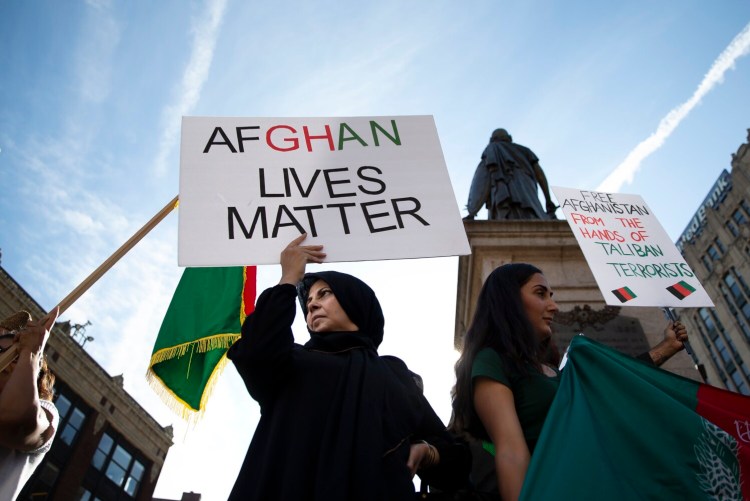 PORTLAND, ME - AUGUST 20: Zezenab Hedayat of Portland holds a sign while demonstrating with fellow members of Maine’s Afghan-American community in Monument Square on Friday to call attention to the plight of loved ones in Afghanistan. (Davis/Staff Photographer)