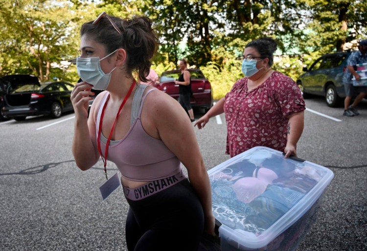 GORHAM, ME - AUGUST 26: Isabella Ross, a freshman from Trenton adjusts her mask before entering Anderson Hall as she and her mom Snow Ross move Isabella into her door room on move in day at the University of Southern Maine Thursday, August 26, 2021. (Staff Photo by Shawn Patrick Ouellette/Staff Photographer)