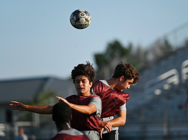 SACO, ME - AUGUST 31: Thornton Academy's Pedro Hernandez Alvarez, left, and Ronan Flynn go up for the ball during a soccer intrasquad scrimmage at Thornton Academy Tuesday, August 31, 2021. (Staff Photo by Shawn Patrick Ouellette/Staff Photographer)