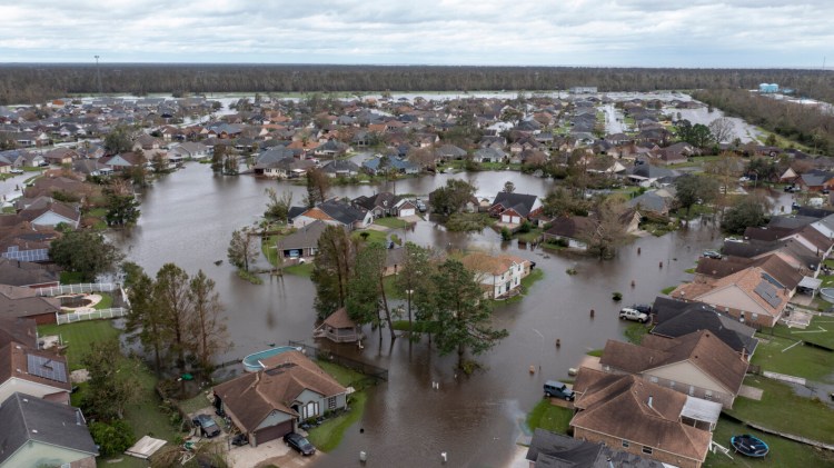 Streets and homes in the Spring Meadow subdivision in LaPlace, La., are flooded on Monday after Hurricane Ida. It's estimated that  hurricane damage will cause a 0.2 percent drag in U.S. gross domestic product this quarter.