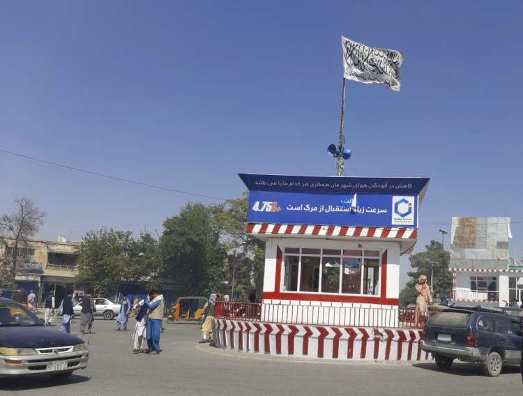 A Taliban flag flies in the main square of Kunduz city after fighting between Taliban and Afghan security forces, in Kunduz, Afghanistan, on Sunday. Taliban fighters Sunday took control of much of the capital of northern Afghanistan's Kunduz province, including the governor's office and police headquarters, a provincial council member said. 