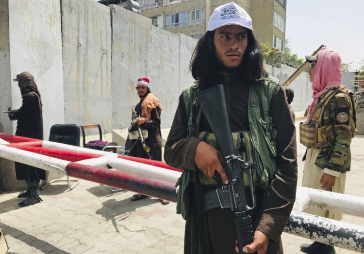 Taliban fighters stand guard at a checkpoint that was previously manned by American troops near the U.S. embassy in Kabul, Afghanistan, on Tuesday. 