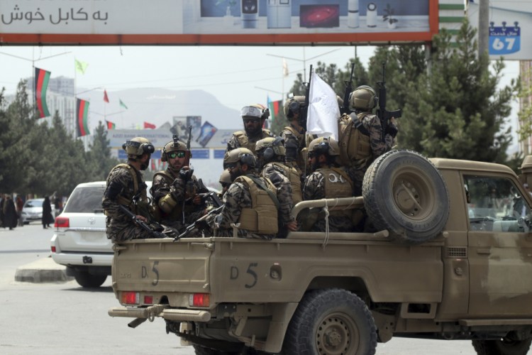 Taliban special force fighters arrive inside the Hamid Karzai International Airport after the U.S. military's withdrawal, in Kabul, Afghanistan, on Tuesday. The Taliban were in full control of Kabul's international airport on Tuesday, after the last U.S. plane left its runway, marking the end of America's longest war. 