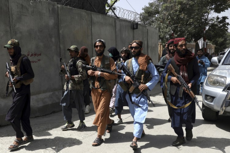Taliban fighters patrol in Wazir Akbar Khan neighborhood in the city of Kabul, Afghanistan, on Wednesday. The Taliban declared an "amnesty" across Afghanistan and urged women to join their government Tuesday, seeking to convince a wary population that they have changed. 