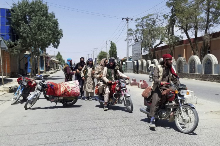 Taliban fighters patrol the city of Ghazni, southwest of Kabul, Afghanistan, on Thursday. The Taliban captured the provincial capital near Kabul on Thursday, part of a weeklong blitz across Afghanistan as the U.S. and NATO prepare to withdraw entirely from the country after decades of war. 