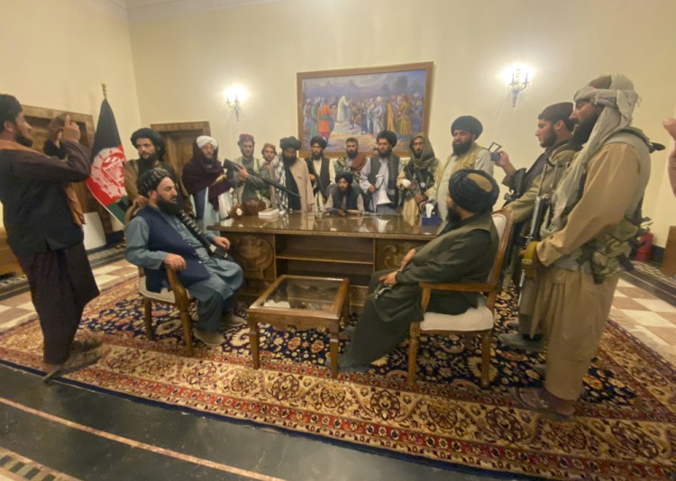 Taliban fighters take control of Afghan presidential palace after the Afghan President Ashraf Ghani fled the country, in Kabul, Afghanistan, Sunday.