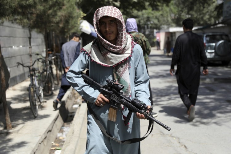 A Taliban fighter stands guard at a checkpoint in the Wazir Akbar Khan neighborhood in  Kabul, Afghanistan, on Sunday.

