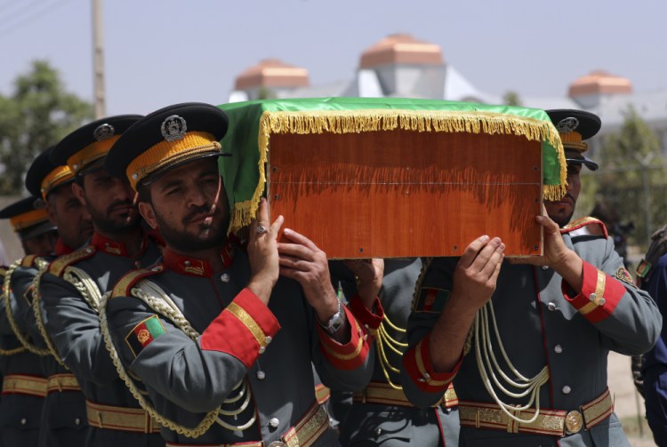 Afghan honor guards carry the coffin of Dawa Khan Menapal, director of Afghanistan's Government Information Media Center who was shot and killed in Kabul, on Saturday.
