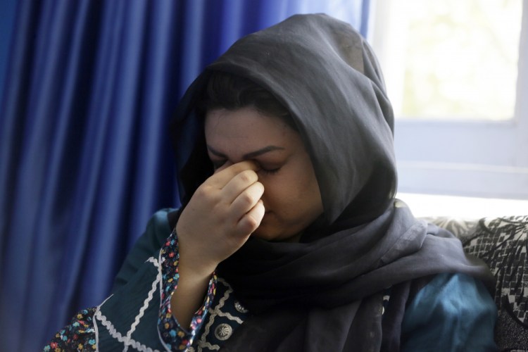 Zarmina Kakar, a women's rights activist, cries during an interview with the Associated Press in Kabul, Afghanistan, on Friday. Kakar was only a year old when the Taliban entered Kabul the first time in 1996, and recalled a time when her mother took her out to buy her ice cream, back when the Taliban ruled. Her mother was whipped by a Taliban fighter for revealing her face for a couple of minutes. “Today again, I feel that if Taliban come to power, we will return back to the same dark days,” she said.