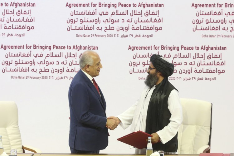 U.S. peace envoy Zalmay Khalilzad, left, and Mullah Abdul Ghani Baradar, the Taliban group's top political leader shake hands after signing a peace agreement between Taliban and U.S. officials Feb. 29, 2020, in Doha, Qatar.