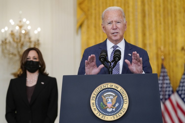 President Biden speaks about the evacuation of American citizens, their families, special visa applicants and vulnerable Afghans in the East Room of the White House on Friday. Vice President Kamala Harris listens at left. 