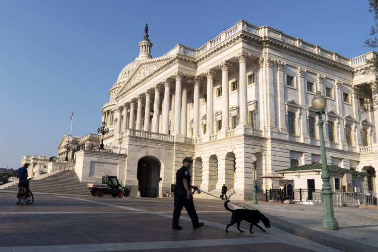 U.S. Capitol Police patrol the perimeter of the U.S. Capitol in July. On Monday, Capitol police announced the findings of their internal investigation into the fatal shooting of Ashli Babbitt during the Jan. 6 riot.
