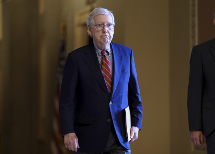 Senate Minority Leader Mitch McConnell, R-Ky., walks to the chamber as the Senate works to advance the $1 trillion bipartisan infrastructure bill, at the Capitol in Washington on Monday. 
