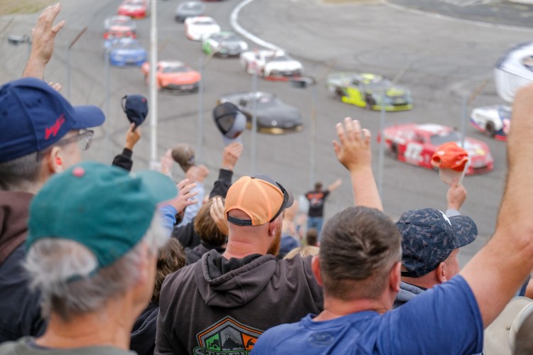 Race fans wave to the competitors before the green flag at the 2021 Oxford 250 at Oxford Plains Speedway.