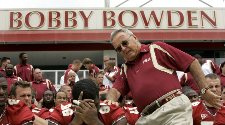 Florida State head football coach Bobby Bowden, right, squeezes into his seat for a team photo during media day activities in Tallahassee in 2007. The Hall of Fame college football coach Bobby Bowden has died after a battle with pancreatic cancer. Exuding charm and wit, Bowden led Florida State to two national championships and a record of 315-98-4 during his 34 seasons with the Seminoles. In all, Bowden had 377 wins during his 40 years in major college coaching. He was 91 years old. 