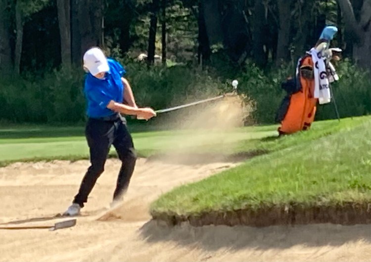 Freeport's Eli Spaulding hits out of a sand trap on the sixth hole at Val Halla Golf Course during the final round of the New England Junior Amateur Golf Championship on Tuesday.