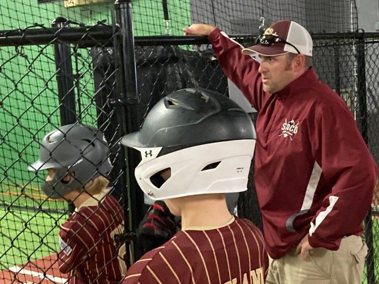 Manager Jamie Gagnon watches his Saco Little League baseball team during batting practice Thursday at Hitter's Count in Saco.