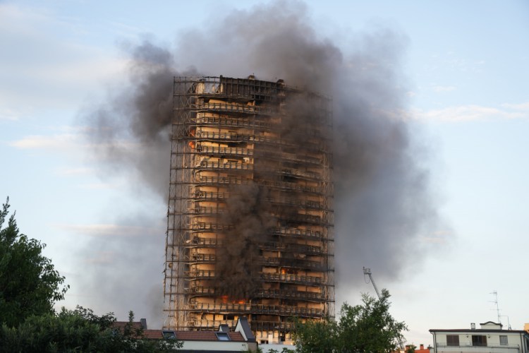 Smoke billows from a building in Milan, Italy, on Sunday.

