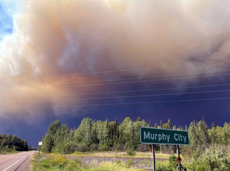 Smoke and a pyrocumulus cloud rise above Highway 1 near Murphy City, Minn, on Monday. 

