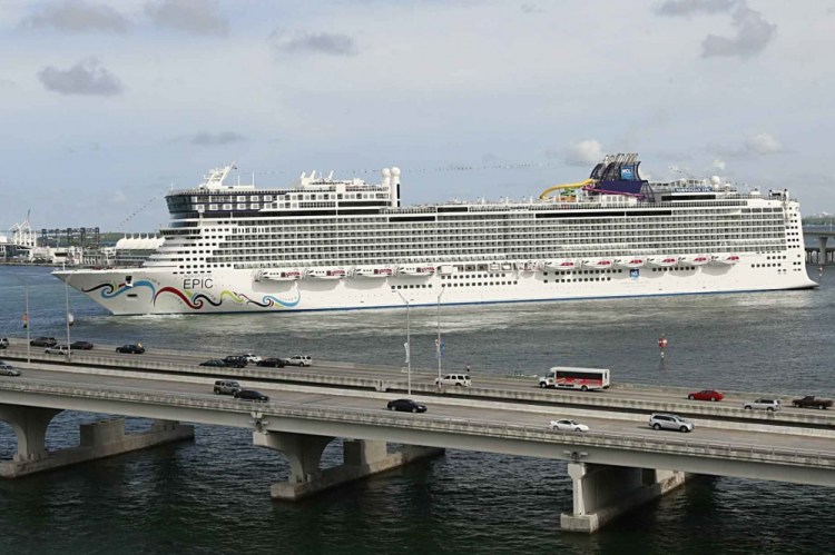 The Norwegian Epic, owned by the Norwegian Cruise Line Corporation, sails through the Government Cut to the Port of Miami in Miami in July 2010. A federal judge on Sunday night, Aug. 8, 2021, granted Norwegian Cruise Line’s request to temporarily block a Florida law banning cruise companies from asking passengers for proof of coronavirus vaccination before they board a ship. 