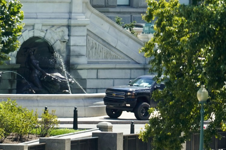A pickup truck is parked on the sidewalk in front of the Library of Congress on Thursday. A man sitting in the pickup truck outside the Library of Congress told police that he had a bomb.
