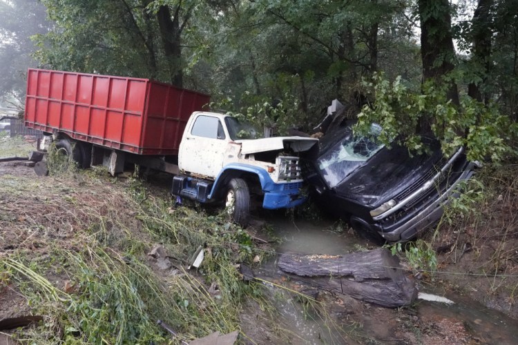 A truck and a car sit in a creek Sunday after they were washed away the day before in McEwen, Tenn. 

