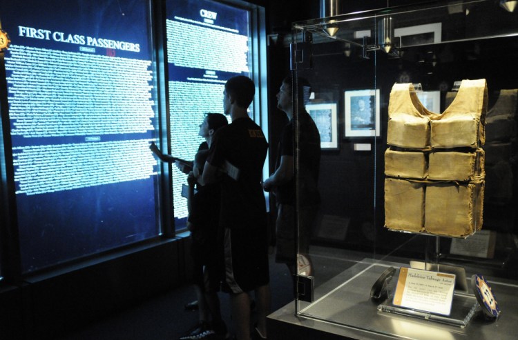 Visitors check the passenger list against their boarding pass to see if they were a survivor or casualty of the sinking of the ship at the Titanic Museum in Pigeon Forge, Tenn.(Curt Habraken/The Mountain Press via AP, File)