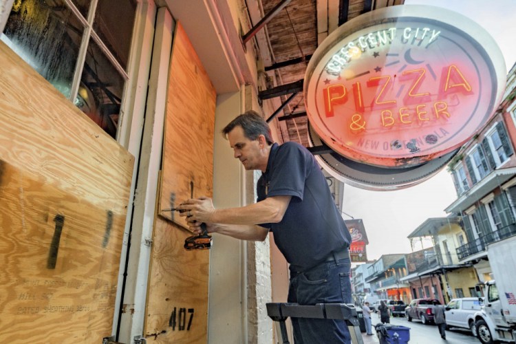 Michael Richard of Creole Cuisine Restaurant Concepts boards up Crescent City Pizza on Bourbon Street in the French Quarter before landfall of Hurricane Ida in New Orleans on Saturday.