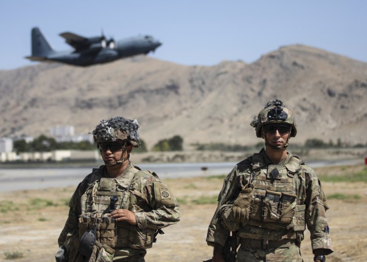 Two paratroopers assigned to the 1st Brigade Combat Team, 82nd Airborne Division, conduct security while a C-130 Hercules takes off during a evacuation operation in Kabul, Afghanistan, on Wednesday. 