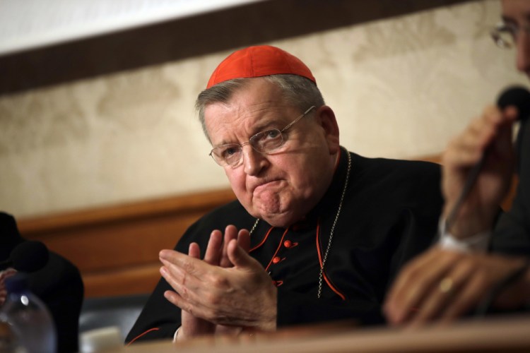 Cardinal Raymond Burke applauds during a press conference at the Italian Senate, in Rome on Sept. 6, 2018. 