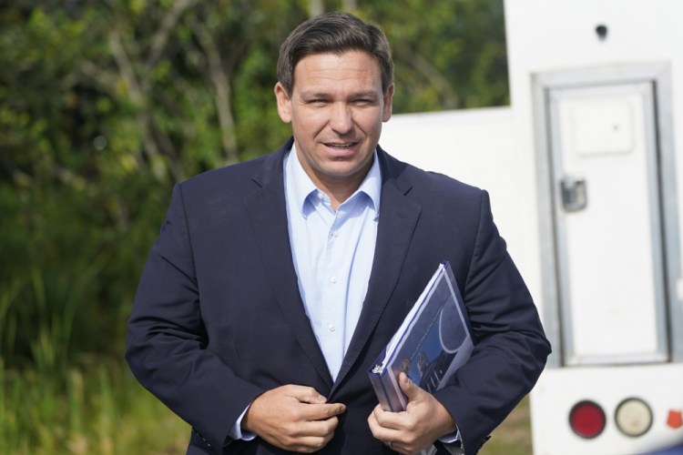 Florida Gov. Ron DeSantis arrives at a news conference Tuesday in Miami. 