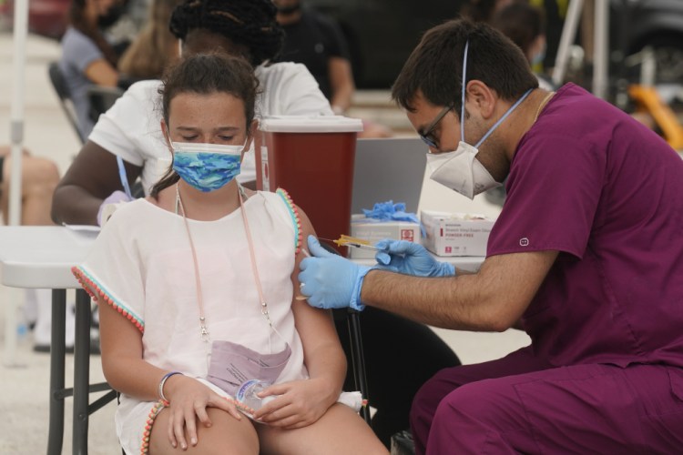 Francesca Anacleto, 12, receives her first Pfizer COVID-19 vaccine shot from nurse Jorge Tase, Wednesday, Aug. 4, 2021, in Miami Beach, Fla. 