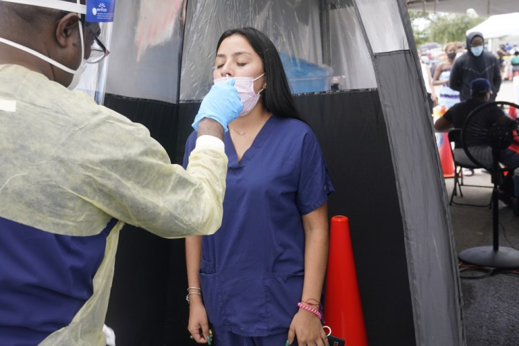 Janice Perez, a clinical technician, is tested for COVID-19, after a colleague at her office recently tested positive, Monday, Aug. 9, 2021, in North Miami. Florida continues to report more cases of COVID-19 as the highly contagious delta variant is affecting mostly unvaccinated people. 