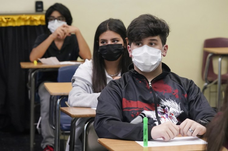 Students sit in an algebra class at Barbara Coleman Senior High School on the first day of school, Monday, Aug. 23, in Miami Lakes, Fla. Miami-Dade County public schools require students to wear a mask to prevent the spread of COVID-19. 