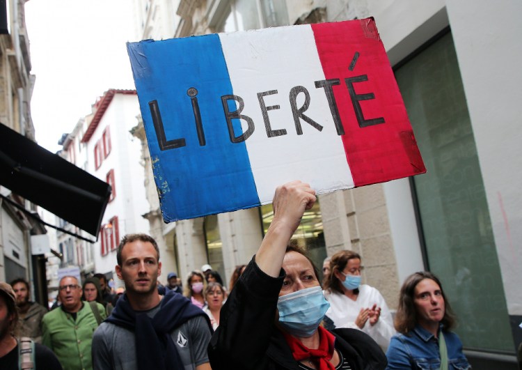 A protester holds a sign in Bayonne, southwestern France, on Saturday. 