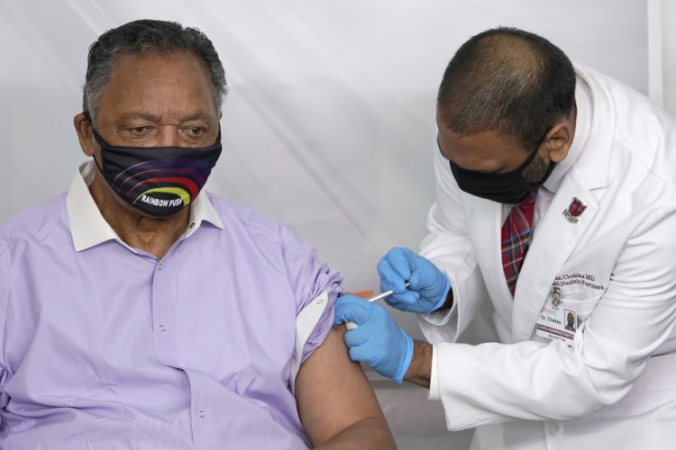 Rev. Jesse Jackson receives the Pfizer's BioNTech COVID-19 vaccine from Dr. Kiran Chekka in January. 