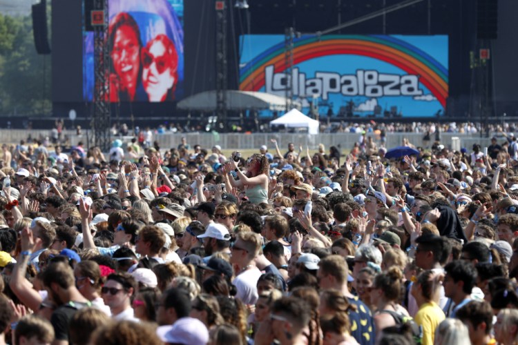 Fans gather and cheer on day one of the Lollapalooza music festival at Grant Park in Chicago on July 29. 


