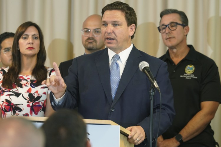 Florida Gov. Ron DeSantis answers questions related to school openings and the wearing of masks in Surfside, Fla. on Aug. 10. Top Republicans are battling school districts in their own states’ urban, heavily Democratic areas over whether students should be required to mask up as they head back to school. 