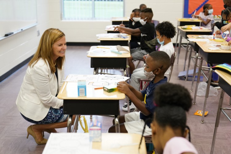 Henry County Board of Education Chair Holly Cobb, left, talks to students at Tussahaw Elementary school on Wednesday, Aug. 4, 2021, in McDonough, Ga.  