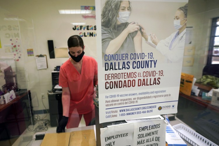 A Dallas County Health and Human Services nurse completes paperwork after administering a Pfizer COVID-19 vaccine at a site in Dallas on Thursday.

