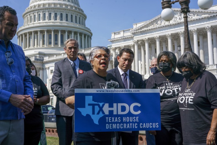 Texas state Rep. Senfronia Thompson, dean of the Texas House of Representatives, is joined by Sen. Jeff Merkley, D-Ore., left center, and other Texas Democrats, as they continue their protest of restrictive voting laws, at the Capitol in Washington, on Friday. 

