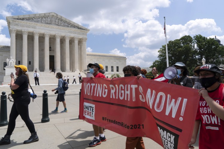 Voting rights activists march outside the U.S. Supreme Court, during a rally Aug. 2 on Capitol Hill in Washington. In the nation’s capital on Saturday,  multiracial coalitions of civil, human and labor rights leaders are convening rallies and marches to urge passage of federal voter protections that have been eroded since the Voting Rights Act of 1965. 

