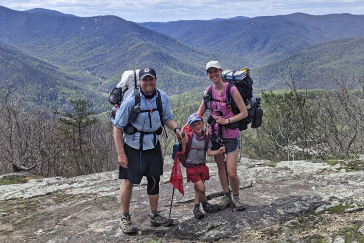 Five-year-old Harvey Sutton poses with his mom, Cassie, and dad, Joshua, at a mountain top in Three Ridges, Virginia, while hiking the Appalachian Trail on April 11.