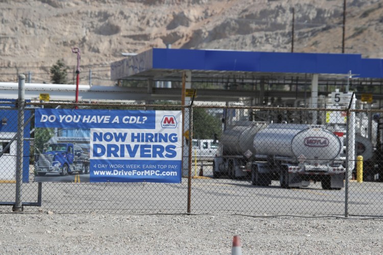 A Marathon Petroleum oil refinery in Salt Lake City posts a hiring sign for drivers. In 2019, the U.S. was already short 60,000 drivers, according to the American Trucking Associations. That number is anticipated to swell to 100,000 by 2023, according to Bob Costello, the group's chief economist.