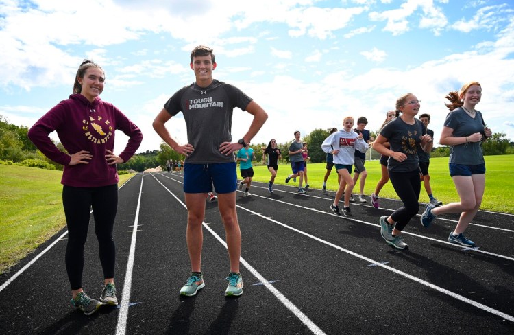 Cape Elizabeth senior cross country runners Ella Bromage and Carter Abrahamsen. "Running was coping," Bromage says of dealing with lockdowns during the pandemic. "It was a super healthy way for me to spend my time and clear my head."
