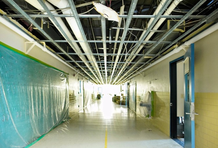 Ceiling tiles were removed from a hallway at Westbrook High School because of a fire and subsequent water damage that closed the school and forced students back to remote learning.