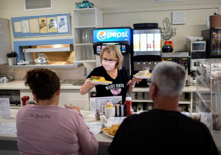 WELLS, ME - SEPTEMBER 3:  Juanita Lucas serves customers at the Maine Diner in Wells on Friday. The restaurant opened Friday after closing for a week because one of its cooks was infected with covid. (Davis/Staff Photographer)